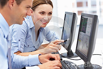 Businessman and woman working on computers Stock Photo
