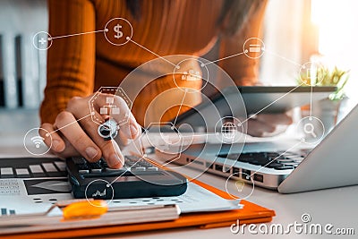 Businessman working on calculator to calculate financial data report, accountancy document and laptop computer at office. Stock Photo