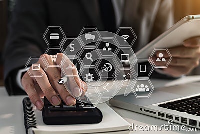 Businessman working on calculator to calculate financial data report, accountancy document and laptop computer at office. Stock Photo