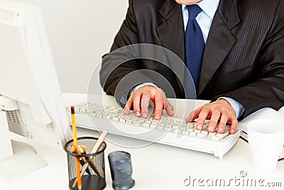 Businessman working on computer. Closeup on hands. Stock Photo