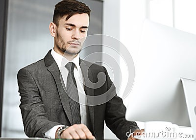 Businessman working with computer in modern office. Headshot male entrepreneur or manager at workplace. Business concept Stock Photo