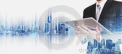 Businessman working on digital tablet with double exposure Bangkok city, concepts of real estate business development Stock Photo