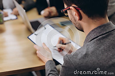 Businessman working with documents in modern office. Back view Stock Photo