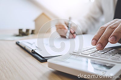 Businessman working doing finances and calculation cost of real estate investment while be signing to contract, Concept mortgage Stock Photo