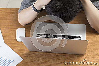 Businessman working with laptop on table at office - frustrate, upset, stress Stock Photo