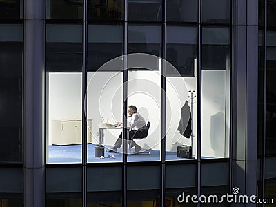 Businessman Working Late Night In Office Stock Photo