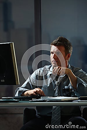 Businessman working late in office Stock Photo