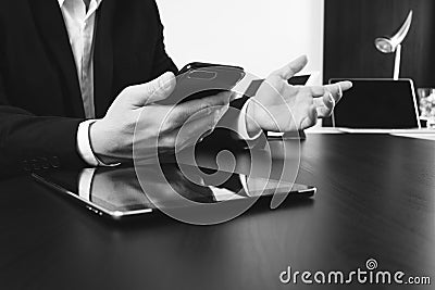 businessman working with smart phone and digital tablet and laptop computer in modern office,balck and white Stock Photo