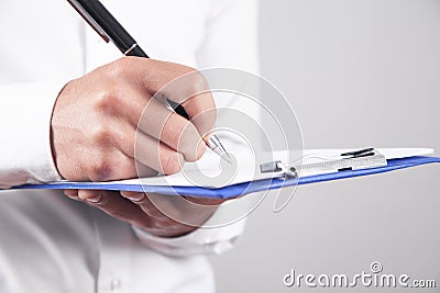 Businessman writes in clipboard. Business concept Stock Photo