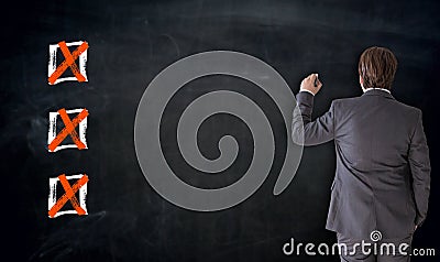 Businessman writing with checkbox concept on blackboard Stock Photo