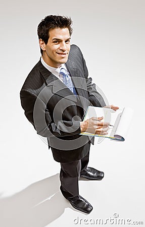 Businessman writing on clipboard Stock Photo