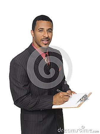 Businessman - writing on clipboard Stock Photo