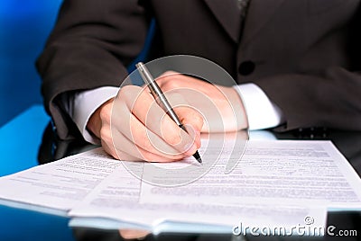 Businessman writing on a form Stock Photo