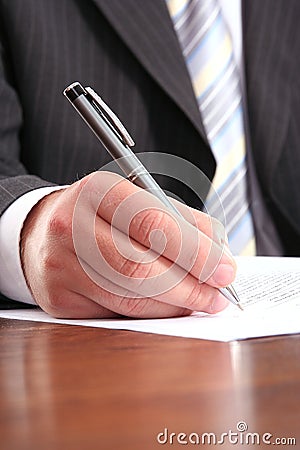 Businessman writing on a form Stock Photo