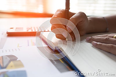 Businessman writing on notebook on wooden table, Concept finance planing and analyzes. Stock Photo