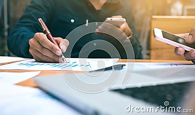 Businessman writing or pointing summary report chart and using s Stock Photo