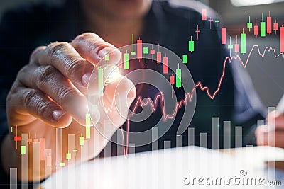 Businessman writing the trading graph of stock market on the virtual screen Stock Photo