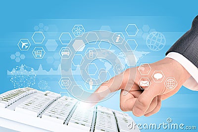 Businessmans hand with keyboard and icons Stock Photo