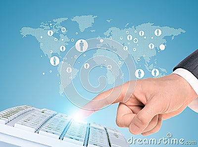 Businessmans hand with keyboard and world map Stock Photo