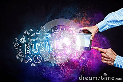 Businessmans hands holding a small magic paper box, mixed media Stock Photo