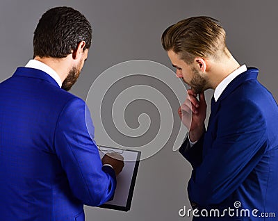 Businessmen assess the terms of the deal. ontracts and arrangem Stock Photo