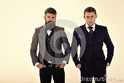 Businessmen, business partners, isolated on white. Mature serious businessman wears old fashioned suit with bow tie Stock Photo