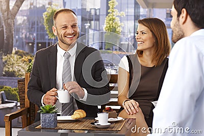 Businessmen and businesswoman relaxing at cafe Stock Photo