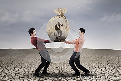 Businessmen carrying a sackful money Stock Photo