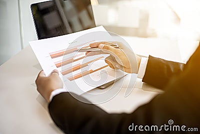 Businessmen are examining company financial information from documents prepared by the finance department Stock Photo