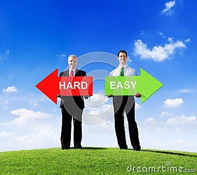 Businessmen Holding Arrows for Hard and Easy Stock Photo