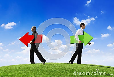 Businessmen Holding Contrasting Arrows Stock Photo