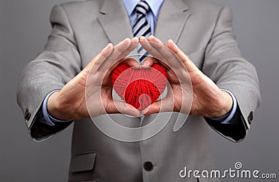 Businessmen is holding out a red heart Stock Photo