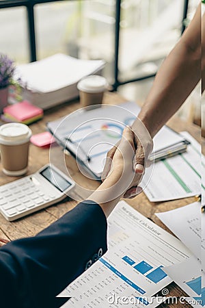 Businessmen join hands for teamwork in business mergers and acquisitions, successful Stock Photo