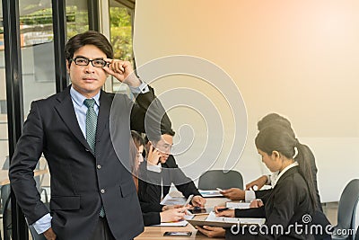 Businessmen meet with middle-aged businessmen standing in front of the table Stock Photo