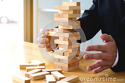 Businessmen picking dominoe blocks to fill the missing dominos a Stock Photo