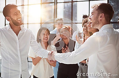 Businessmen reach out to each other to shake hands Stock Photo