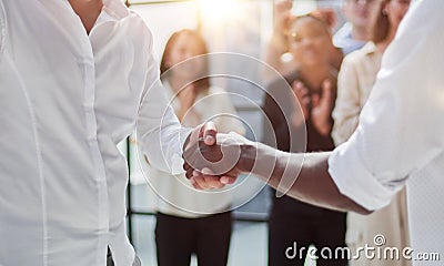 Businessmen reach out to each other to shake hands Stock Photo