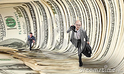 Businessmen running in dollar tunnel Stock Photo
