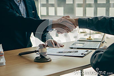 Businessmen shake hands to make deals with male lawyers, judges, legal advisors. Contract consulting services to plan a court case Stock Photo