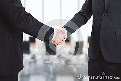 Businessmen shake their hands in conference room Stock Photo