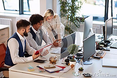 Businessmen showing their progress to the boss. Coworkers looking at the computer and talking about business Stock Photo