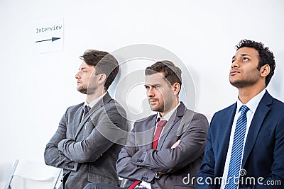 Businessmen sitting in queue and waiting for interview in office Stock Photo