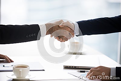 Businessmen in suits handshake after successful negotiation closing deal, closeup Stock Photo