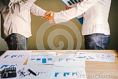 Businessmen together create a mutually beneficial business relationship. Economic graph on the table Stock Photo