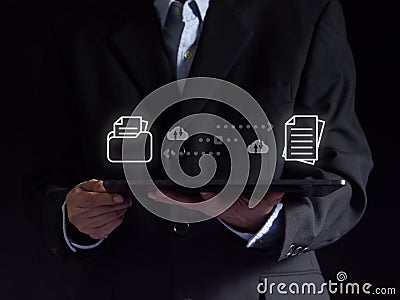 Businessmen use digital tablets to transfer send and receiver or backup company data files via the internet server network. Stock Photo