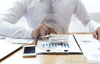 Businessmen use graphs to summarize results and calculate income-expenses to find financial balance points and use them to improve Stock Photo