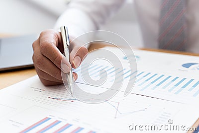 Businessmen use graphs to summarize results and calculate income-expenses to find financial balance points and use them to improve Stock Photo