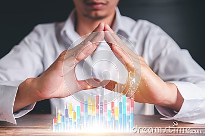 Businessmen use a handle on the wooden block to show stock graphs and rising stock signals with chart indicators. Concepts of Stock Photo