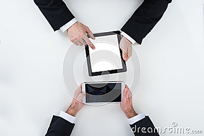 Businessmen Using Digital Tablets At Table In Office Stock Photo