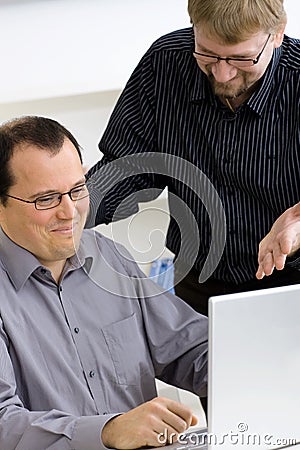 Businessmen using laptop computer Stock Photo